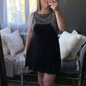 Black mini dress with embroidered pattern